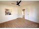 Clean, bright bedroom with ceiling fan and connecting doorway at 719 Washington St, Cramerton, NC 28032