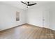 Well-lit bedroom with hardwood floors, a ceiling fan, and neutral color scheme at 719 Washington St, Cramerton, NC 28032