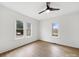 Bright bedroom featuring hardwood floors, large windows, and a ceiling fan at 719 Washington St, Cramerton, NC 28032