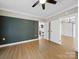 Bright bedroom showcasing luxury vinyl plank flooring with views into the kitchen and bedroom at 719 Washington St, Cramerton, NC 28032