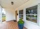 Charming front porch featuring a tiled floor, decorative plants, and a view of the neighborhood at 719 Washington St, Cramerton, NC 28032