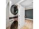 Convenient laundry room with modern, stacked washer and dryer unit, and view to bedroom at 719 Washington St, Cramerton, NC 28032