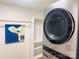 Convenient laundry room featuring modern washer/dryer and custom closet with shelving at 719 Washington St, Cramerton, NC 28032