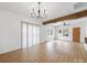 Bright living room with exposed beam, modern lighting and an open floor plan at 719 Washington St, Cramerton, NC 28032