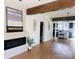 Open-concept living room showcasing a fireplace, hardwood floors and beam at 719 Washington St, Cramerton, NC 28032