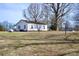 Expansive backyard view of a single story home with a large lawn at 7311 Dogwood Ln, Kannapolis, NC 28081