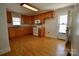Well-lit kitchen featuring wood cabinetry, with a view of a back door at 7311 Dogwood Ln, Kannapolis, NC 28081