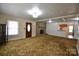 Cozy living room with brick fireplace and view to the kitchen at 7311 Dogwood Ln, Kannapolis, NC 28081