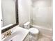 Bathroom with a bathtub and shower, a standard toilet, and an ornate mirror at 807 Limerick Dr, Dallas, NC 28034