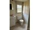 Bathroom with a standard toilet, sink, and textured tiling, awaiting a modern update at 1010 13Th St # 11, Lancaster, SC 29720