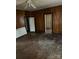 Bedroom with wood-paneled walls, closet, window and access to other rooms at 1010 13Th St # 11, Lancaster, SC 29720
