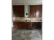 Kitchen with vintage wood cabinets, a stainless steel sink, and tiled backsplash at 1010 13Th St # 11, Lancaster, SC 29720