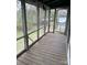 Spacious porch with wood floors and screen panels, offering a view of the surrounding yard at 1010 13Th St # 11, Lancaster, SC 29720