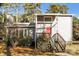 Charming home featuring light siding, a chimney, front stairs and a red front door, surrounded by mature trees at 1052 Palmyra Dr, Fort Mill, SC 29708