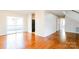 Open living room with hardwood floors, a sliding glass door to the deck, and a staircase in the corner at 1052 Palmyra Dr, Fort Mill, SC 29708