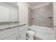Well-lit bathroom features a modern vanity, granite countertop, and tiled shower-over-tub at 107 Adams Tree Way, Troutman, NC 28166