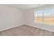 Cozy bedroom featuring neutral carpet, a large window, and ample natural light at 107 Adams Tree Way, Troutman, NC 28166