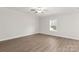 Neutral bedroom with wood-look flooring and a window at 107 Adams Tree Way, Troutman, NC 28166