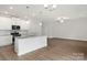 Bright, open kitchen featuring white cabinets, granite countertops, and stainless steel appliances at 107 Adams Tree Way, Troutman, NC 28166