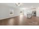 Open-concept living space with wood-look floors, ample natural light, and an island kitchen at 107 Adams Tree Way, Troutman, NC 28166