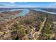 Stunning aerial view of a property surrounded by trees, with a lake in the distance at 109 Gannett Dr, Mooresville, NC 28117