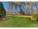 Grassy backyard bordered by mature trees, offering a serene and private outdoor space at 109 Gannett Dr, Mooresville, NC 28117
