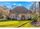 A large, grassy backyard with a view of the home's rear exterior and surrounding trees at 109 Gannett Dr, Mooresville, NC 28117