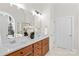Bright bathroom featuring double vanity, wood cabinets, and a large mirror at 109 Gannett Dr, Mooresville, NC 28117