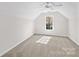 Bright bedroom featuring a large window and neutral carpet at 109 Gannett Dr, Mooresville, NC 28117