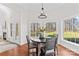 Well-lit dining area with hardwood floors, a fireplace and views of the landscaped backyard at 109 Gannett Dr, Mooresville, NC 28117