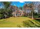Inviting two-story brick home with blue shutters, surrounded by lush greenery at 109 Gannett Dr, Mooresville, NC 28117