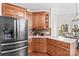 An open kitchen featuring custom wood cabinets, stainless steel refrigerator and a white countertop at 109 Gannett Dr, Mooresville, NC 28117