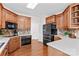 A view of the kitchen showcasing custom wood cabinets, tile backsplash and stainless steel appliances at 109 Gannett Dr, Mooresville, NC 28117