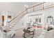 Airy living room with high ceilings, staircase and an open view to the dining area, perfect for entertaining at 109 Gannett Dr, Mooresville, NC 28117
