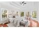 Luxury main bedroom showcasing tray ceilings, many windows and a seating area with neutral decor at 109 Gannett Dr, Mooresville, NC 28117