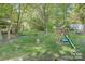 The backyard has a playground set and lots of trees for shade and privacy at 109 Pembrooke Trl # F171, Mount Gilead, NC 27306