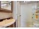Cozy RV bathroom with a sink, mirror, and walk-in shower with shower products at 109 Pembrooke Trl # F171, Mount Gilead, NC 27306