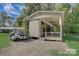 A home with a shaded porch and convenient golf cart parking, perfect for enjoying the outdoors and neighborhood amenities at 109 Pembrooke Trl # F171, Mount Gilead, NC 27306
