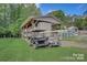 Exterior view showcasing a covered RV and golf carts parked on a lush green lawn, offering a glimpse of leisure and convenience at 109 Pembrooke Trl # F171, Mount Gilead, NC 27306