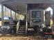 The exterior of the home has a covered deck and steps leading to an RV at 109 Pembrooke Trl # F171, Mount Gilead, NC 27306