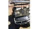 The picture displays a black golf cart, highlighting its features and condition for potential buyers at 109 Pembrooke Trl # F171, Mount Gilead, NC 27306