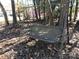 Backyard shows a comfortable metal swing set on a leaf-strewn lot, perfect for relaxation and Gathering fun at 109 Pembrooke Trl # F171, Mount Gilead, NC 27306