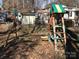 A wooden swing set and slide are in the backyard on a bed of fallen leaves at 109 Pembrooke Trl # F171, Mount Gilead, NC 27306