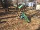 A wooden swing set and slide are in the backyard on a bed of fallen leaves at 109 Pembrooke Trl # F171, Mount Gilead, NC 27306