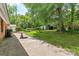 The backyard shows the exterior of the house, lawn, patio and some trees at 1125 Mcdow Dr, Rock Hill, SC 29732