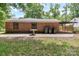 The backyard shows the exterior of the house, lawn, patio and some trees at 1125 Mcdow Dr, Rock Hill, SC 29732