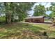 The backyard shows the exterior of the house, lawn, patio and some trees at 1125 Mcdow Dr, Rock Hill, SC 29732