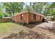 The backyard shows the exterior of the house, lawn, patio and some trees at 1125 Mcdow Dr, Rock Hill, SC 29732