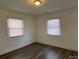 Cozy bedroom with new flooring, white walls, and natural light from two windows at 1125 Mcdow Dr, Rock Hill, SC 29732