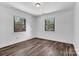 Sunlit bedroom with coordinating floors and two bright windows facing tree-filled backyard at 1125 Mcdow Dr, Rock Hill, SC 29732
